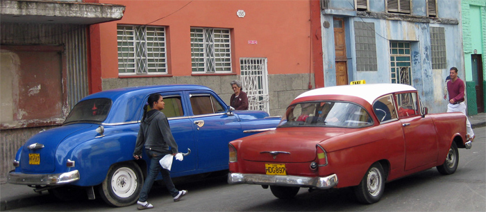 blue Plymouth and dunno what red car