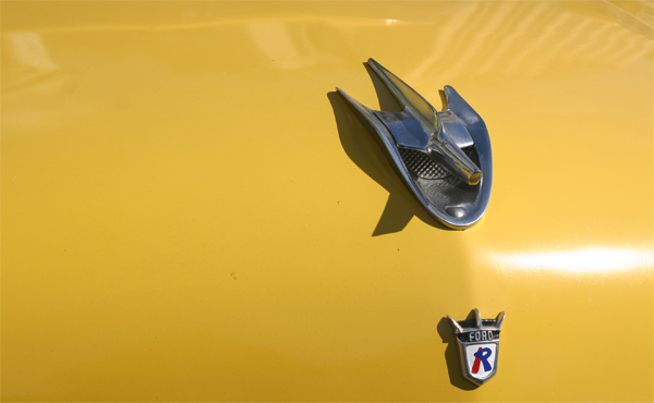 hood ornament of the yellow and white Ford